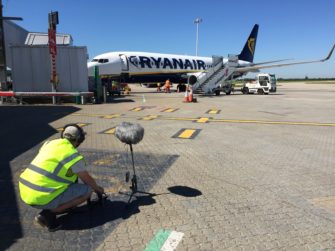 Photograph of Sound Recordist recording aeroplane at gate | Stansted Airport
